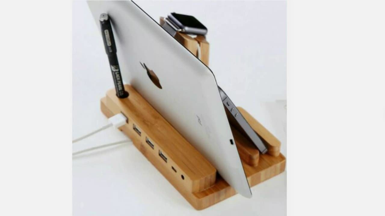 charging dock, black plastic, multiple device slots, smartphones, smartwatches, USB cables, organized charging station