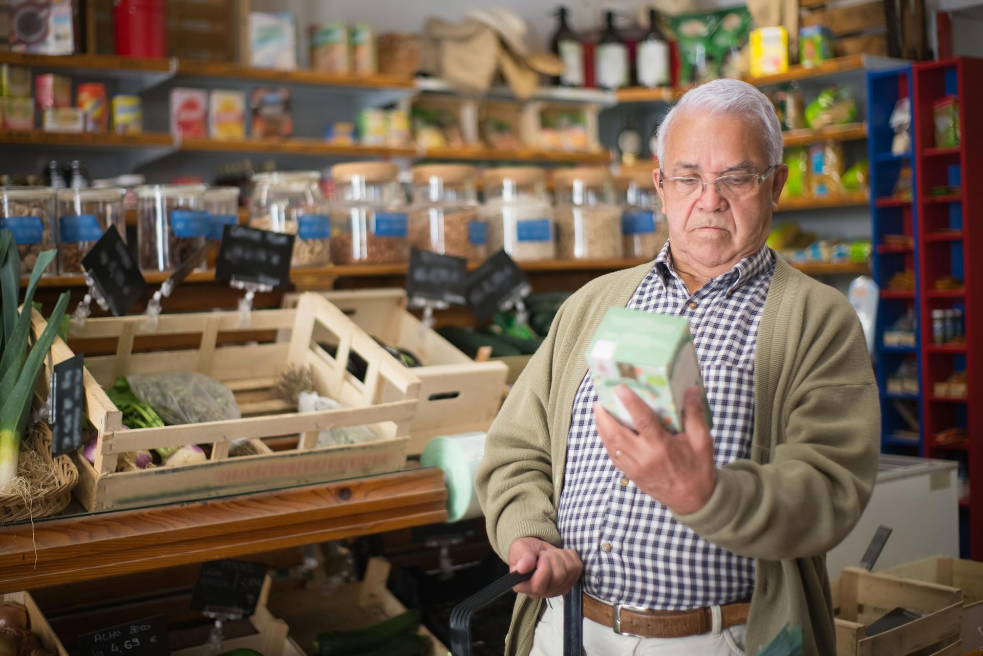 An Elderly Man Looking at a Box