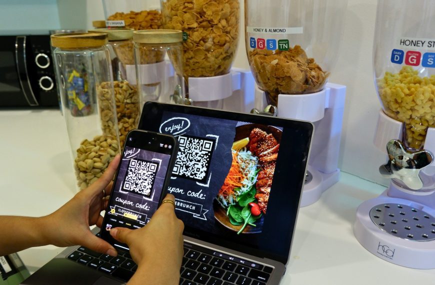 Scanning QR code to avail a restaurant's discount coupon.