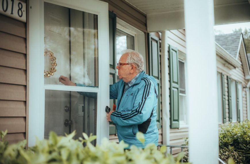 Elderly Man Knocking on House Front Doors