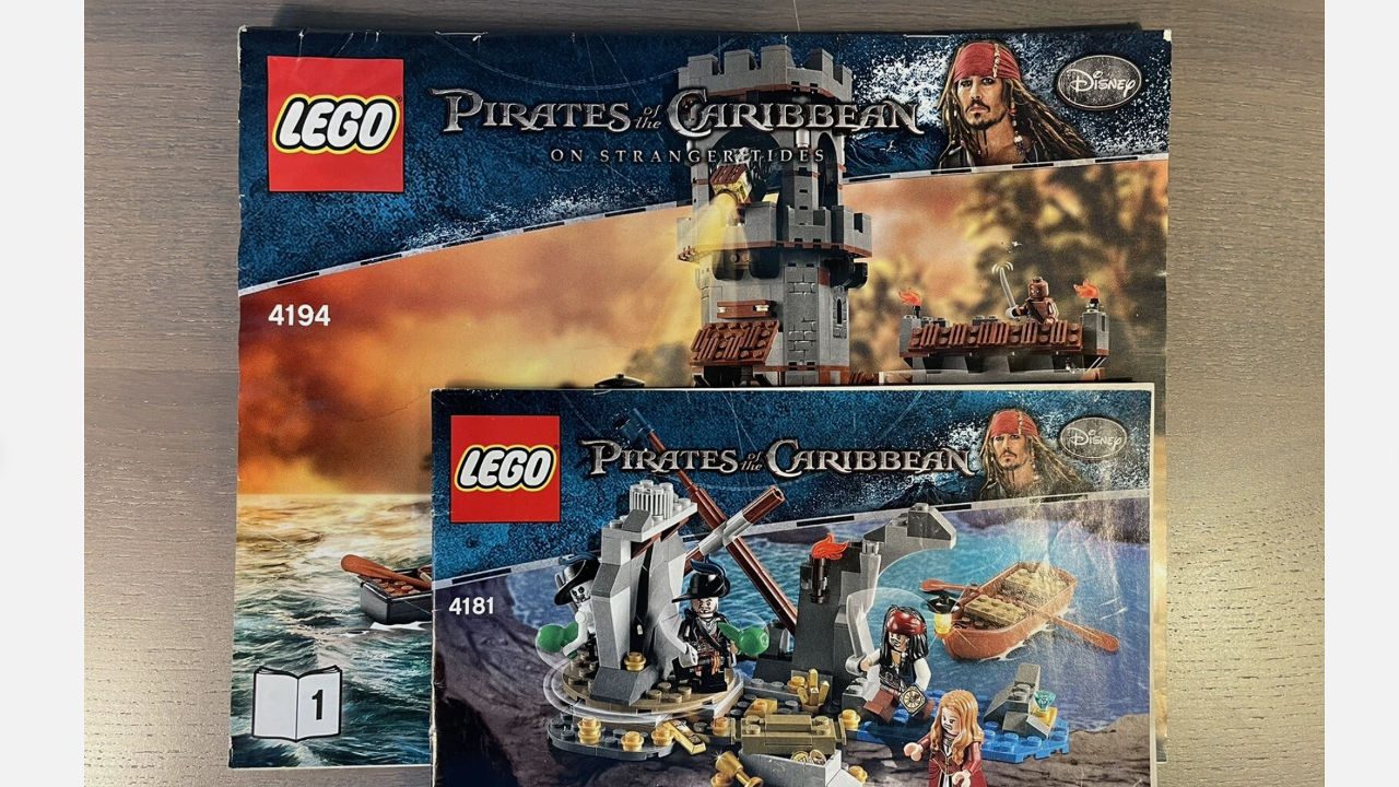 LEGO Pirates of the Caribbean instruction manuals, set 4194 and set 4181, featuring Jack Sparrow, themed builds from On Stranger Tides, displayed on wooden surface