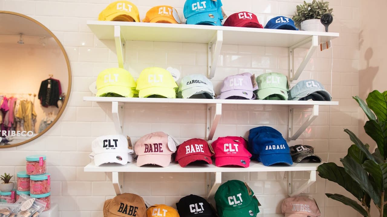 hats on shelf, multiple styles, neatly arranged, wooden shelf, various colors, organized display
