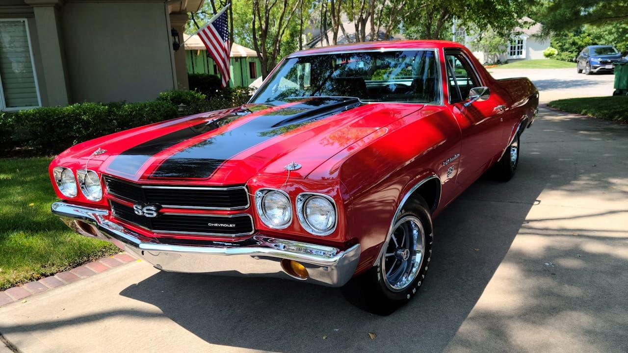 1970 Chevrolet Chevelle SS, classic American muscle car, red body, black racing stripes, chrome trim, two-door coupe, vintage design, aggressive front grille