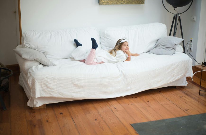 A Girl with Tiara Lying on Front on a Sofa