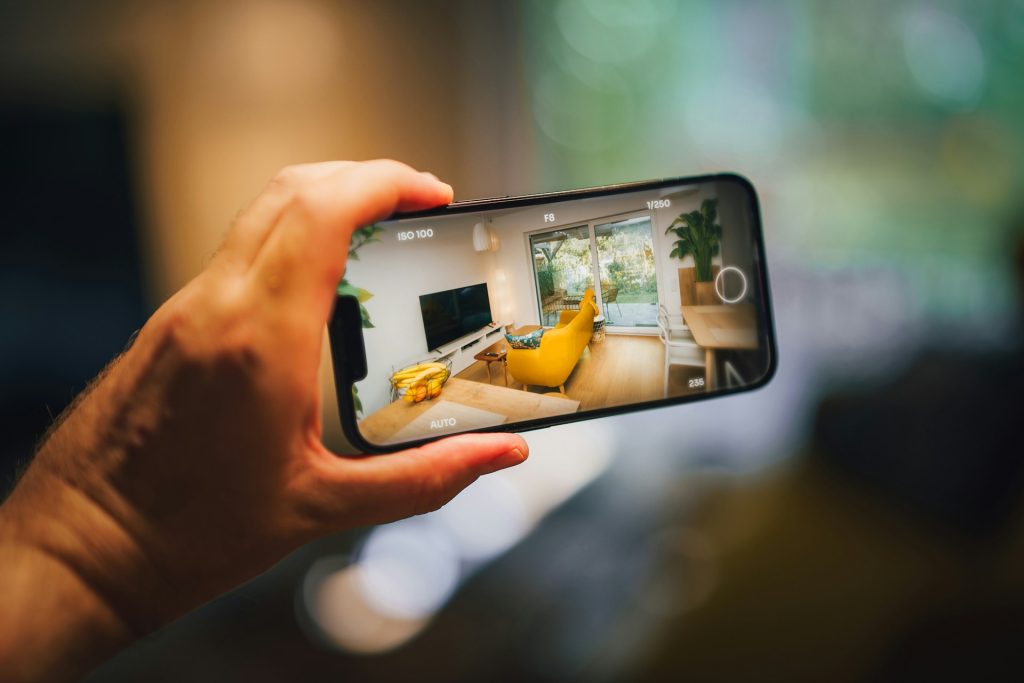 Real estate virtual tour mobile photo camera app. Hand holding smartphone. Home interior