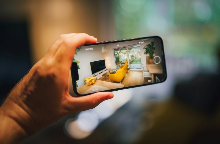 Real estate virtual tour mobile photo camera app. Hand holding smartphone. Home interior