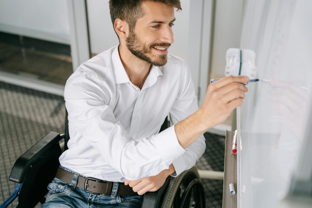Man in White Dress Shirt sitting on a Wheelchair