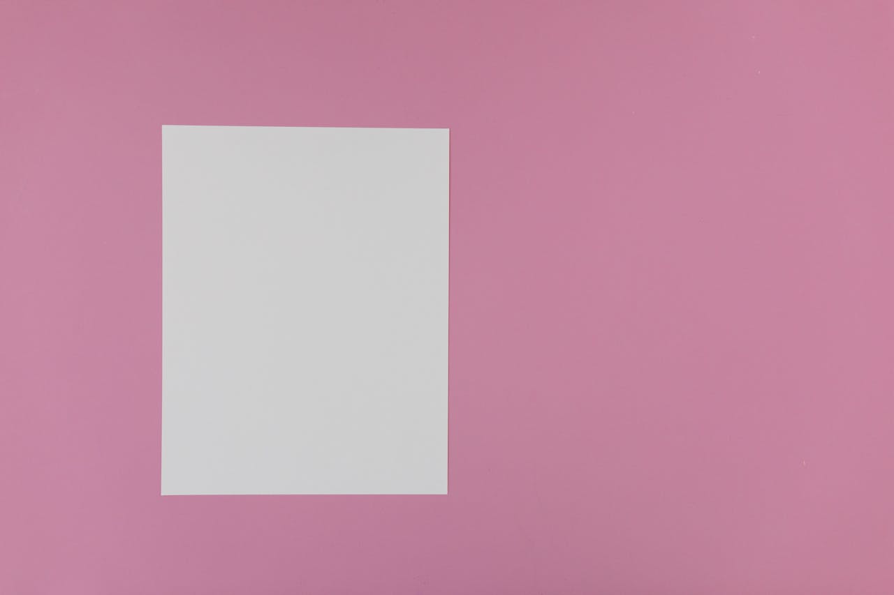An Empty White Bond Paper on a Pink Surface