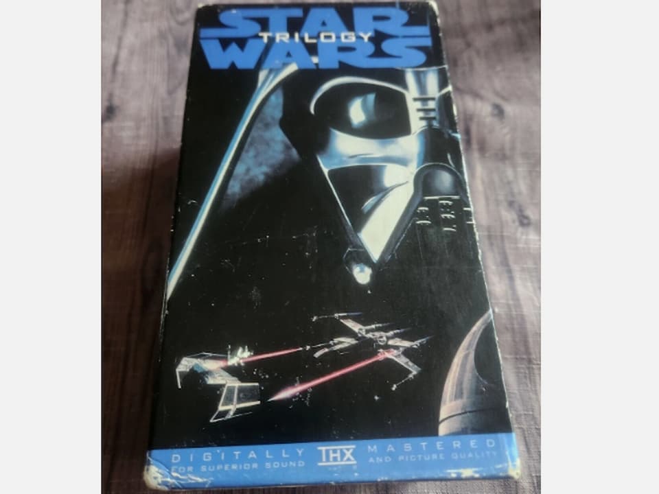 Star Wars Trilogy 1995 VHS box set, gold and black cover design, includes A New Hope, The Empire Strikes Back, and Return of the Jedi, widescreen edition, Lucasfilm logo, boxed with spine art forming Darth Vader’s helmet