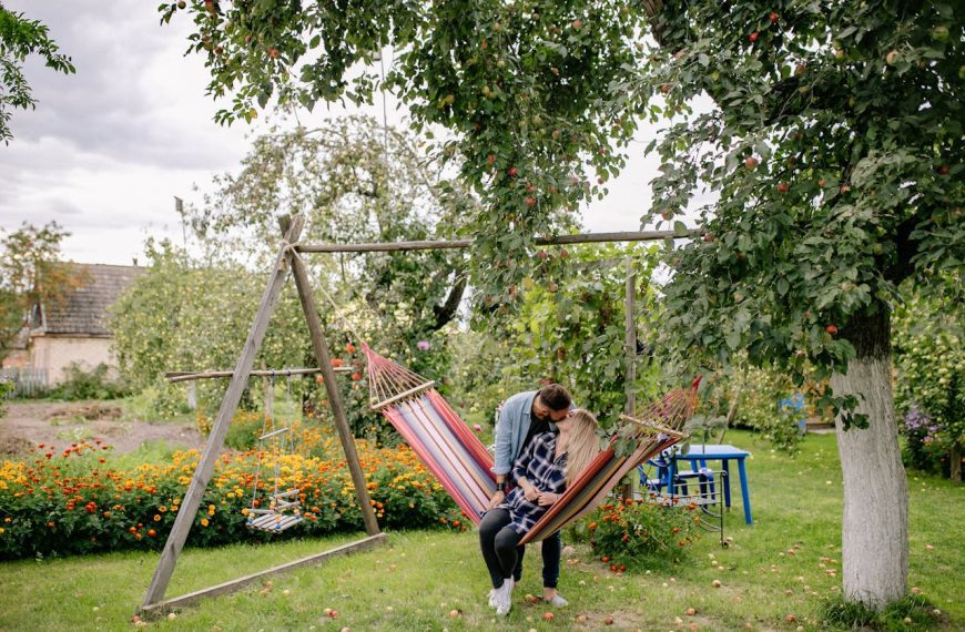 Man in Blue Denim Button Up Shirt Kissing Woman in Blue and White Plaid Shirt