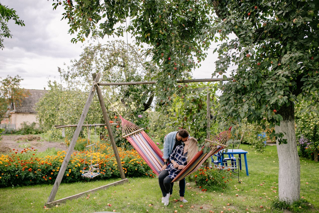 Man in Blue Denim Button Up Shirt Kissing Woman in Blue and White Plaid Shirt