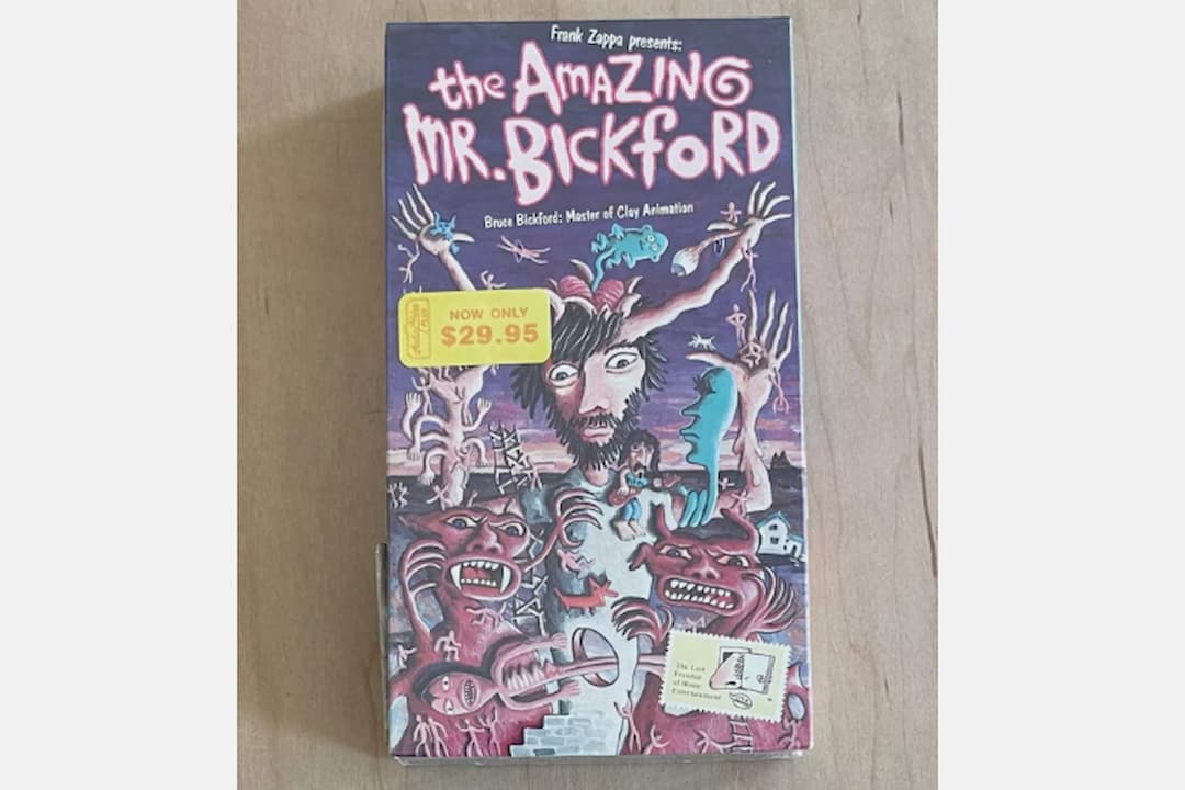 VHS cover of The Amazing Mr. Bickford, presented by Frank Zappa, surreal illustrated artwork with claymation-style monsters and a man’s face, price sticker showing $29.95
