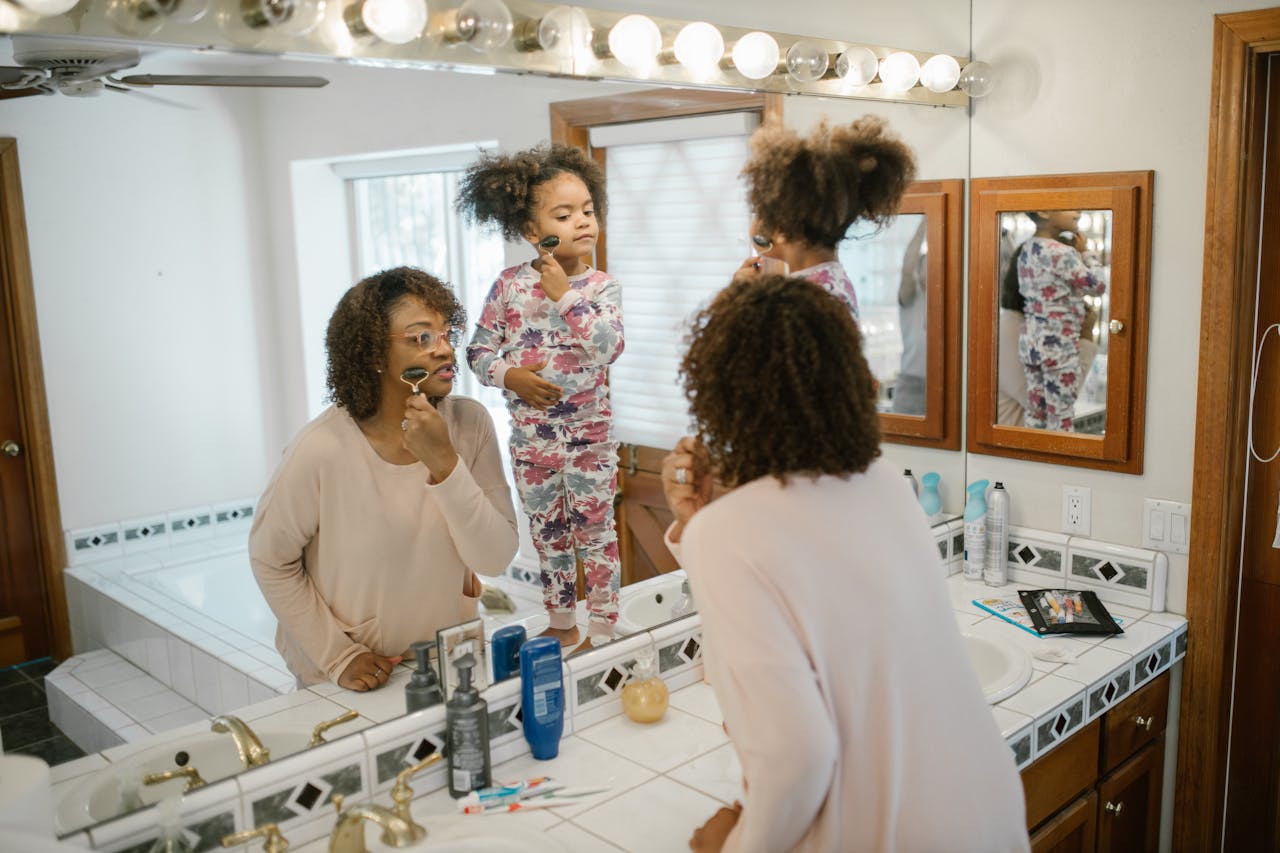 Daughter and Mother Doing Skin Care in Bathroom