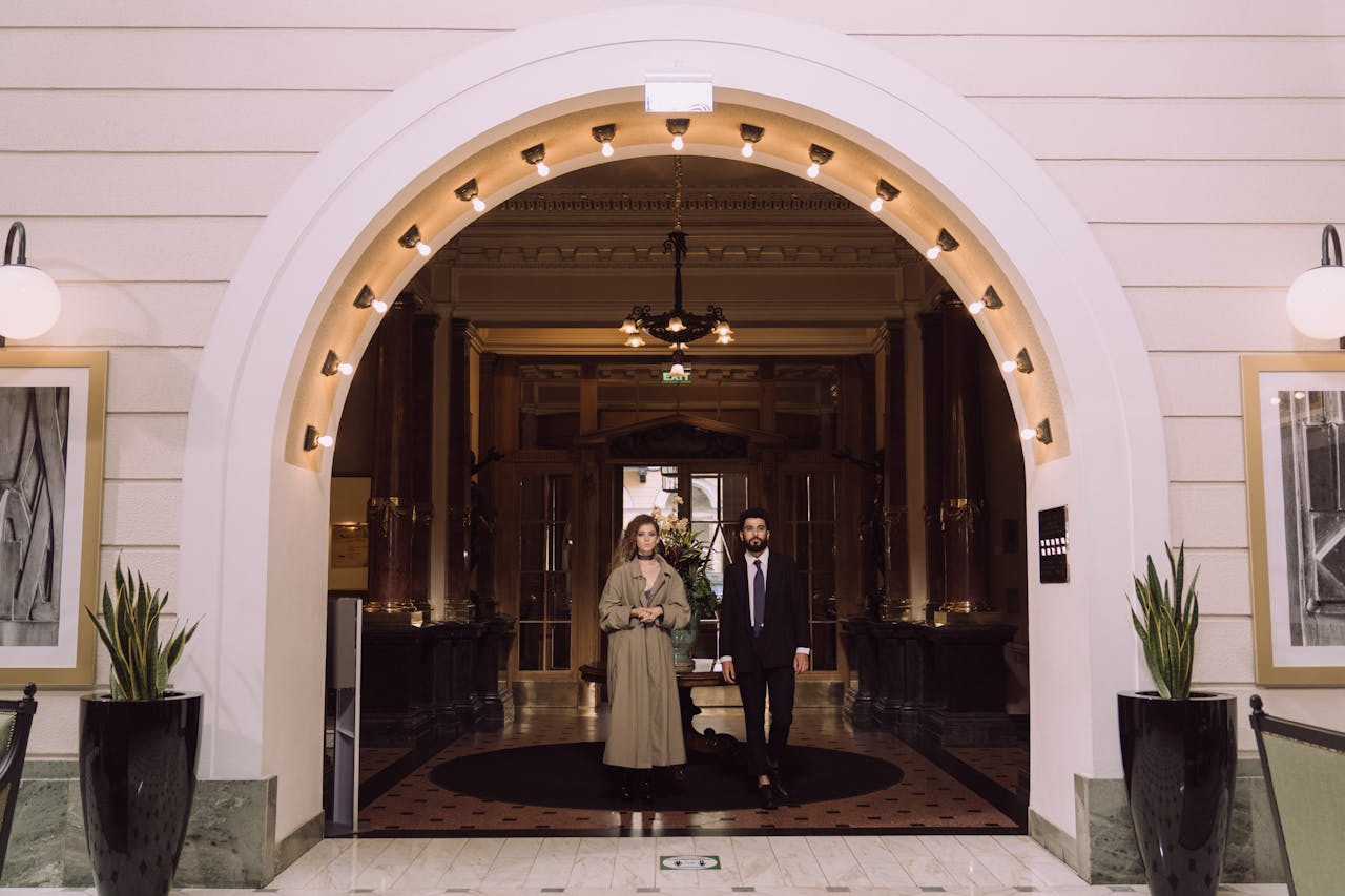 Elegant Couple by the Entrance to a Hotel