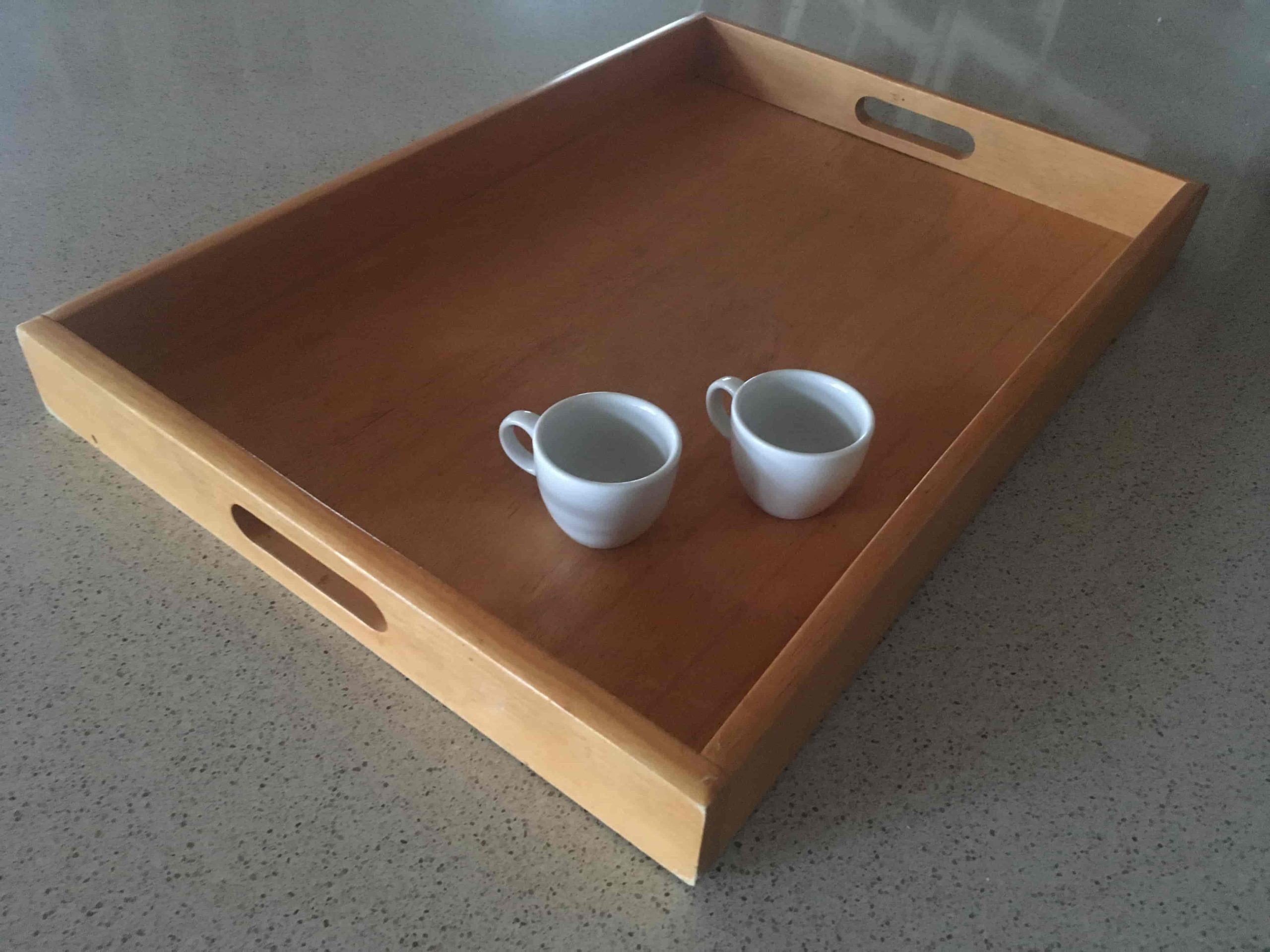 Wooden tray carrying two espresso cups