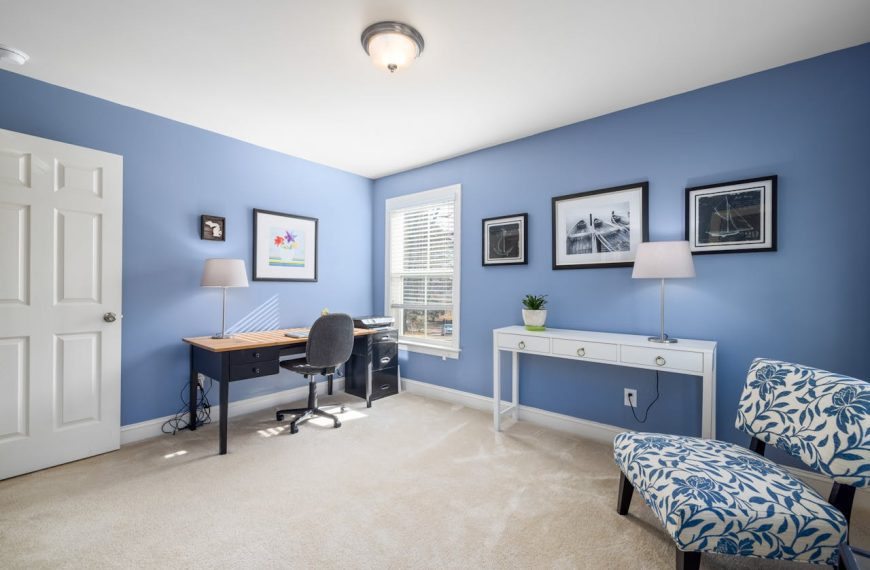 Indoor view of office room with desk and laptop at home