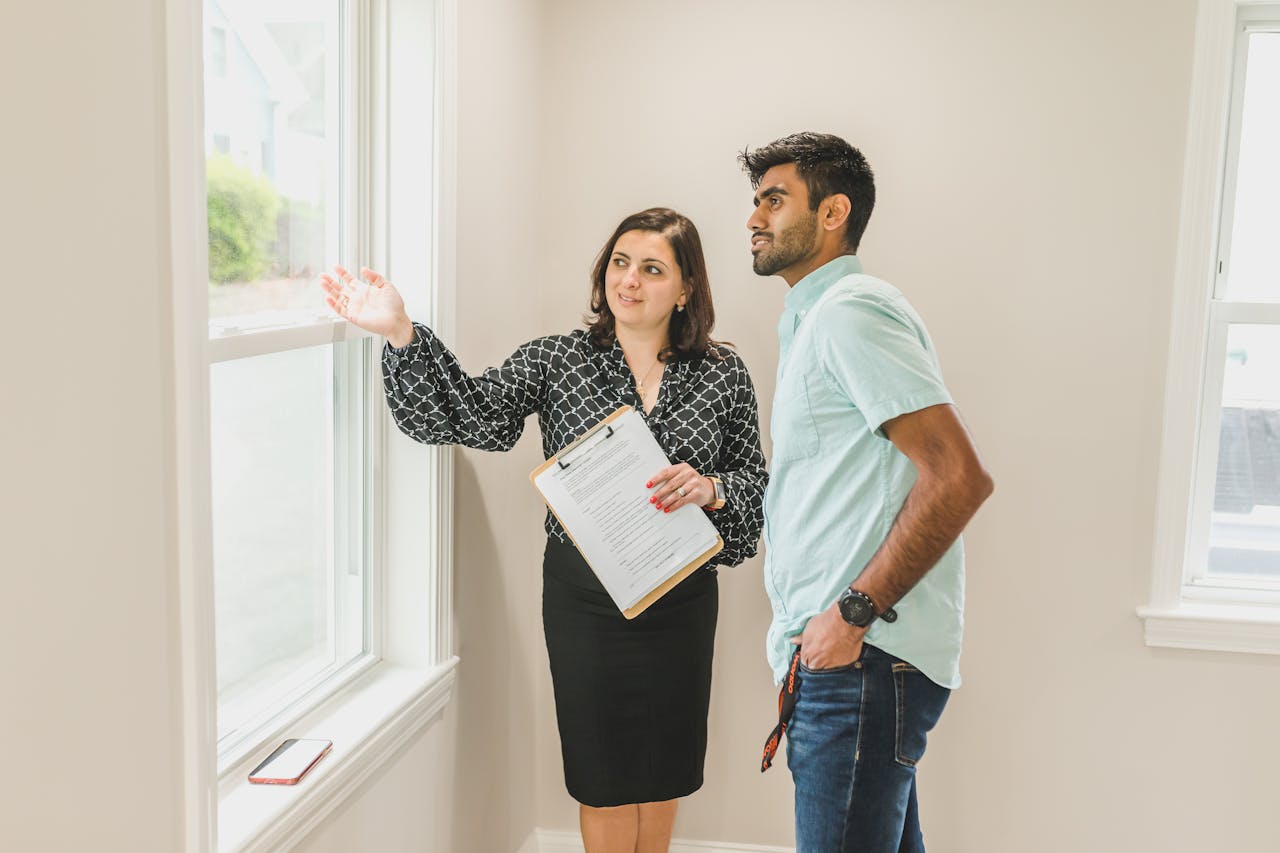 A Woman Talking to the Man while Looking at the Glass Window