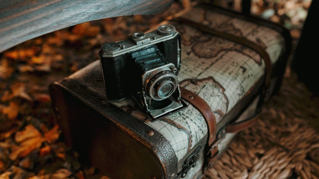 Vintage Camera on Old Map-Trunk in Autumn Setting