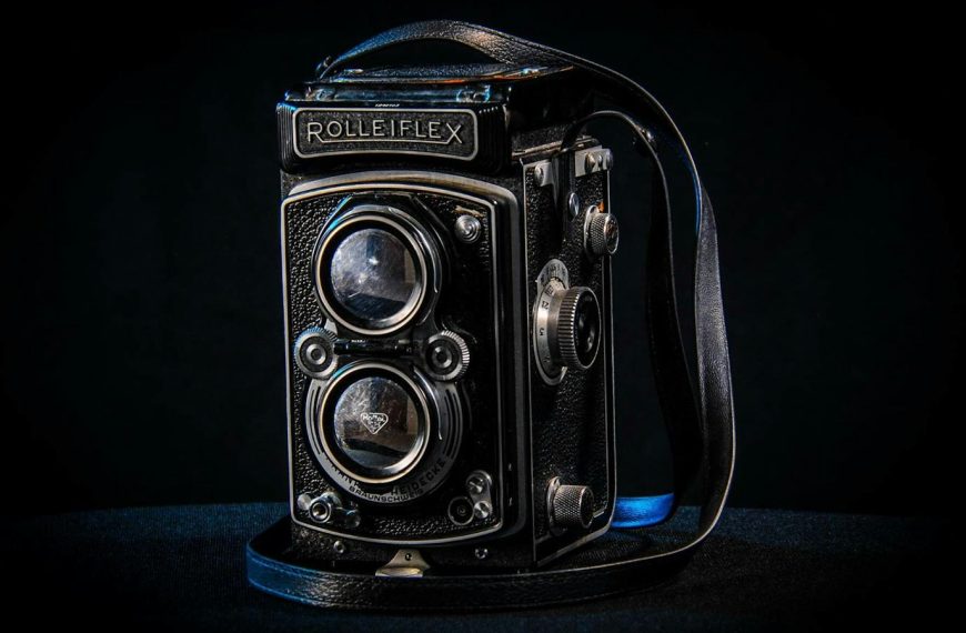 Classic Rolleiflex twin-lens reflex camera with a dark backdrop, highlighting its vintage design.