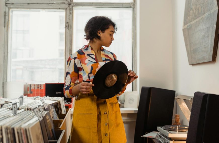 Stylish woman browsing vinyl records in a cozy shop. Music enthusiasts will love the vintage vibe.