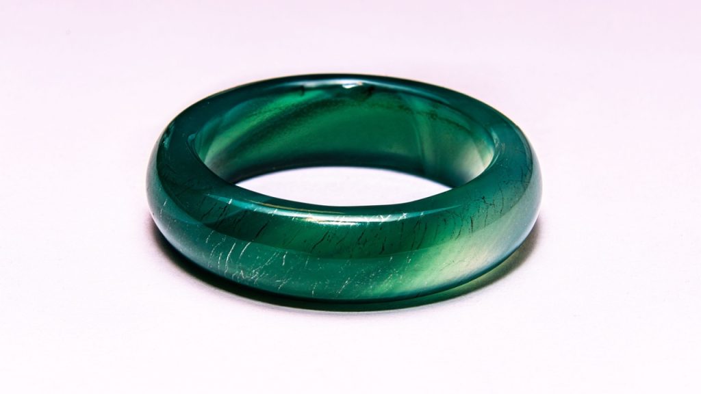 A close-up shot of a green jade ring on a white background