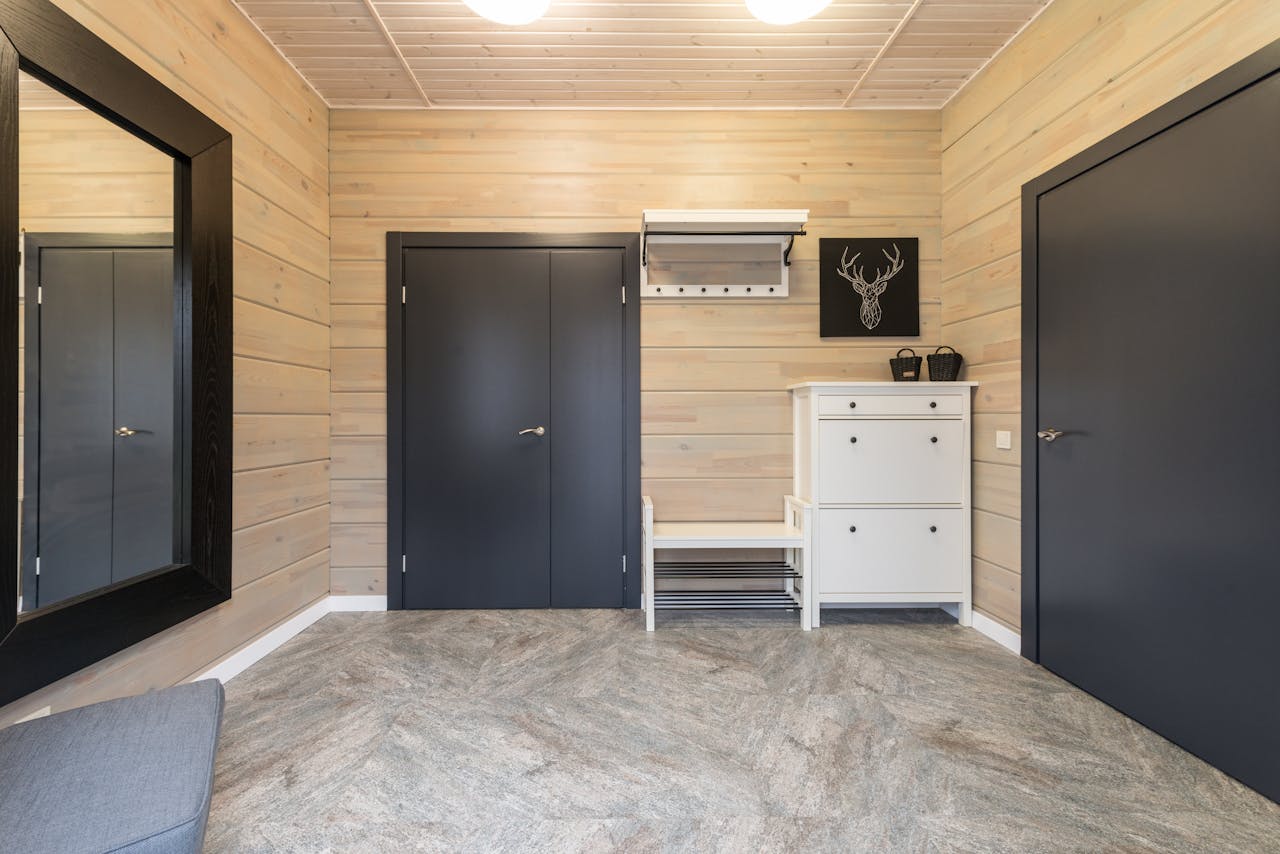 Interior of corridor with doors near cupboard and mirror