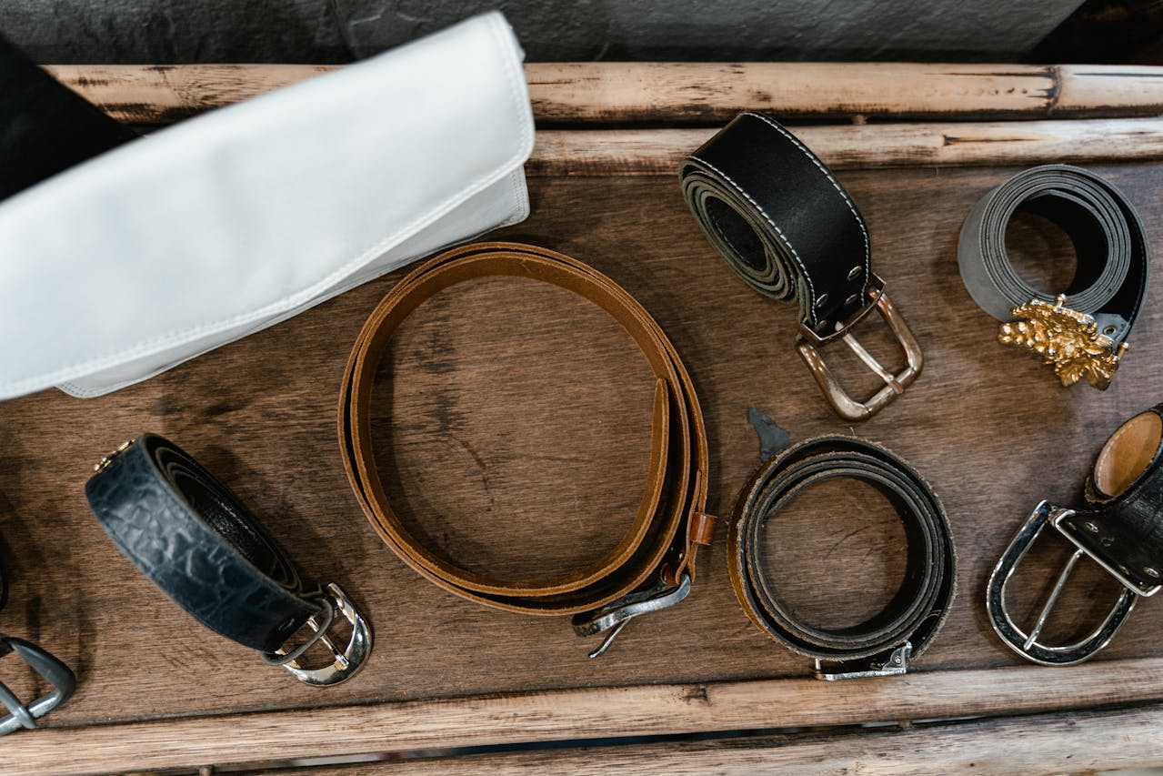Assorted Leather Belts on Wooden Rack