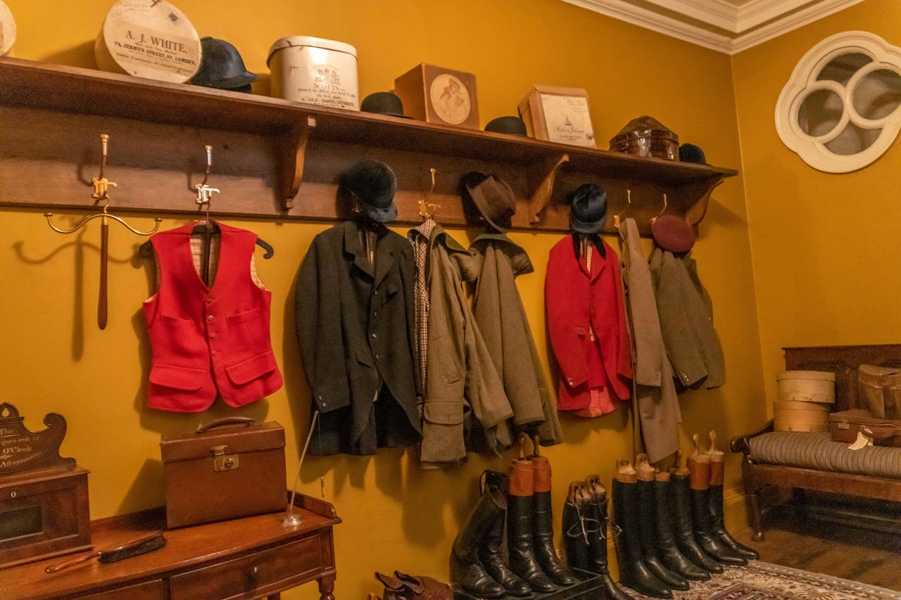 Photo of Multiple Equestrian Shoes and Jackets in Vintage Room