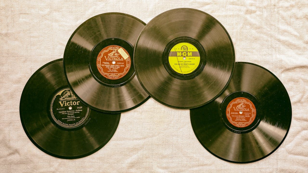 Photo of Vinyl Records on a White Textile