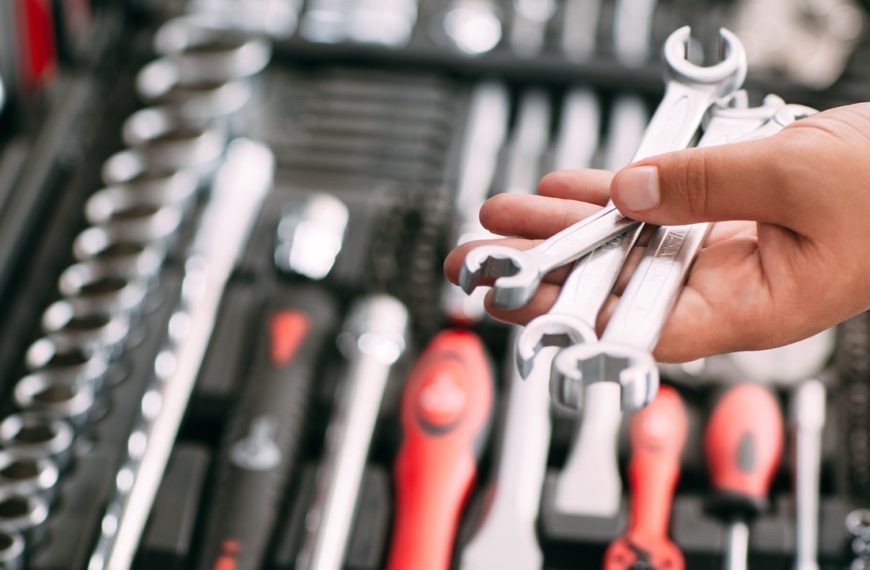 Customers or worker (builder, repairman, handyman) at the store chooses wrench instrument (tools). Display of tools shop marketing for home and auto repair