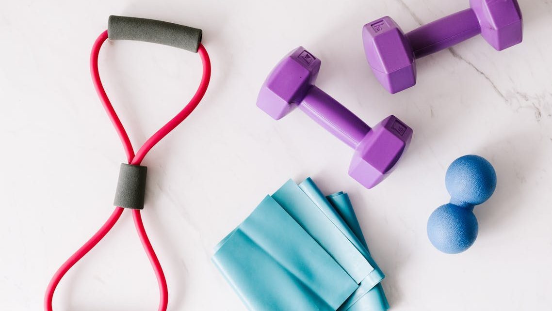 Set of fitness equipment placed on marble surface