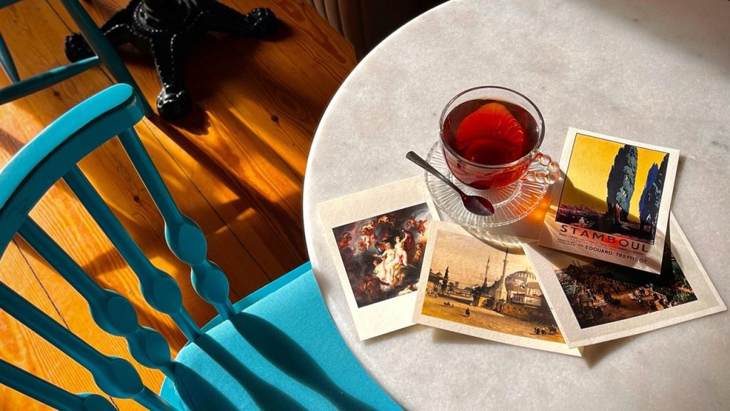 Cozy Cafe Table with Artistic Postcards