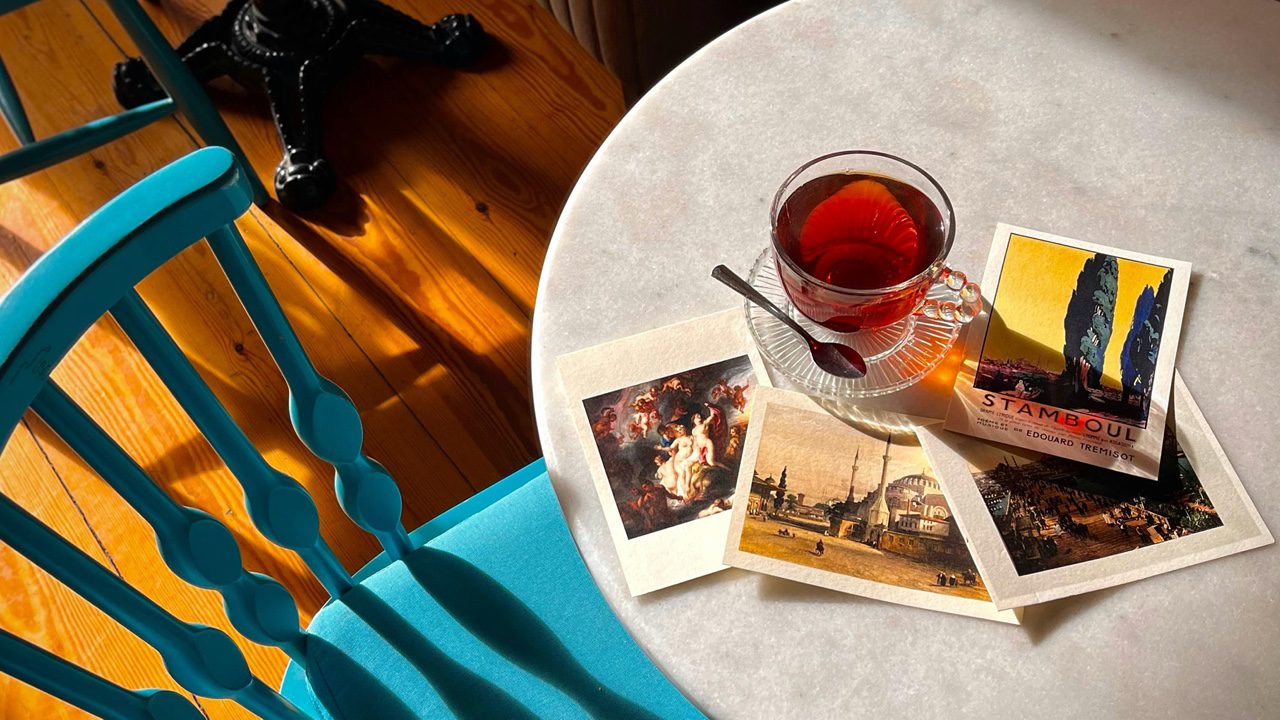 Cozy Cafe Table with Artistic Postcards