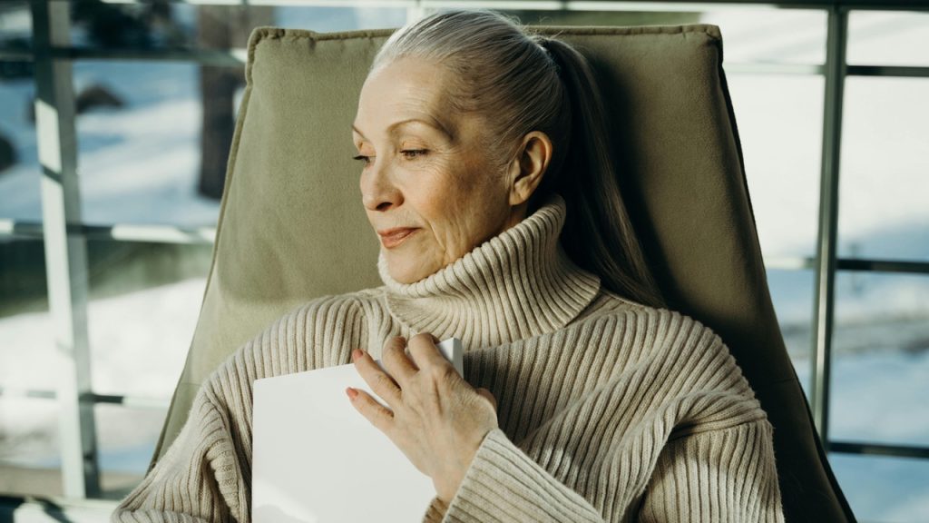Woman hugging book, sentimental