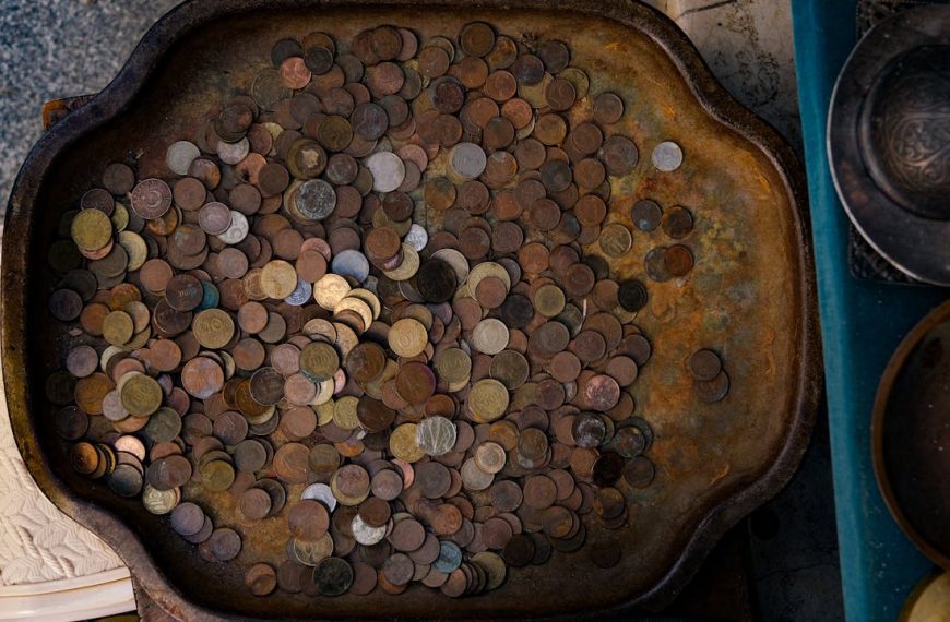 A tray filled with coins and other items