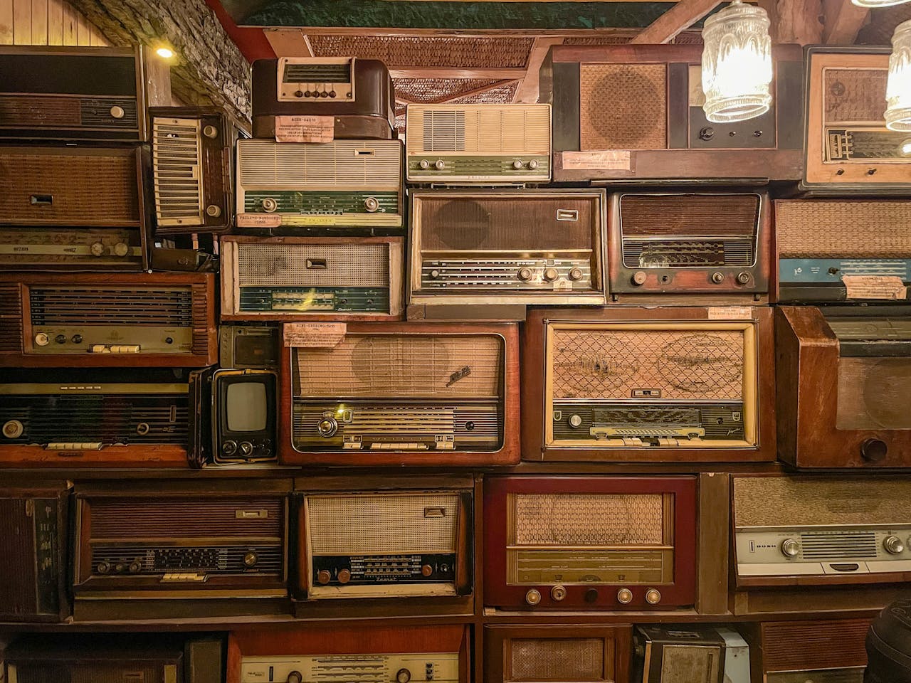 Stack of Vintage Radios and Televisions Indoors