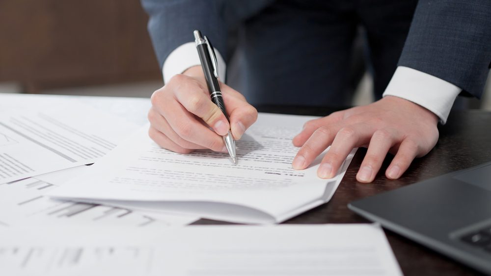 Collector photographing items for documentation