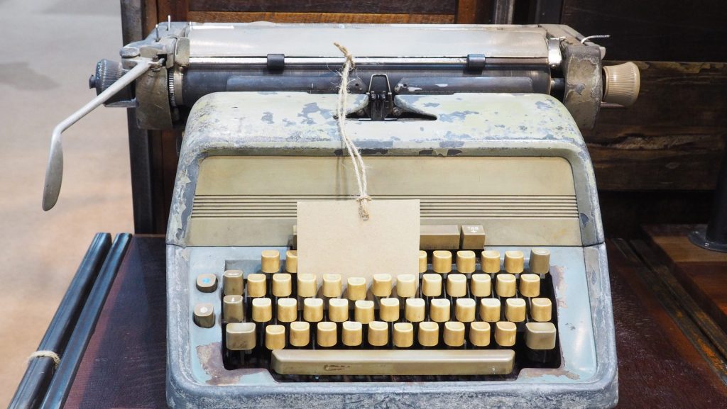vintage typewriter and tag label on the wood desk