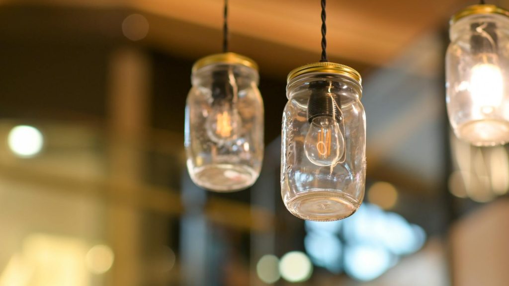 Stylish mason jar lights hanging indoors, creating a warm ambiance.