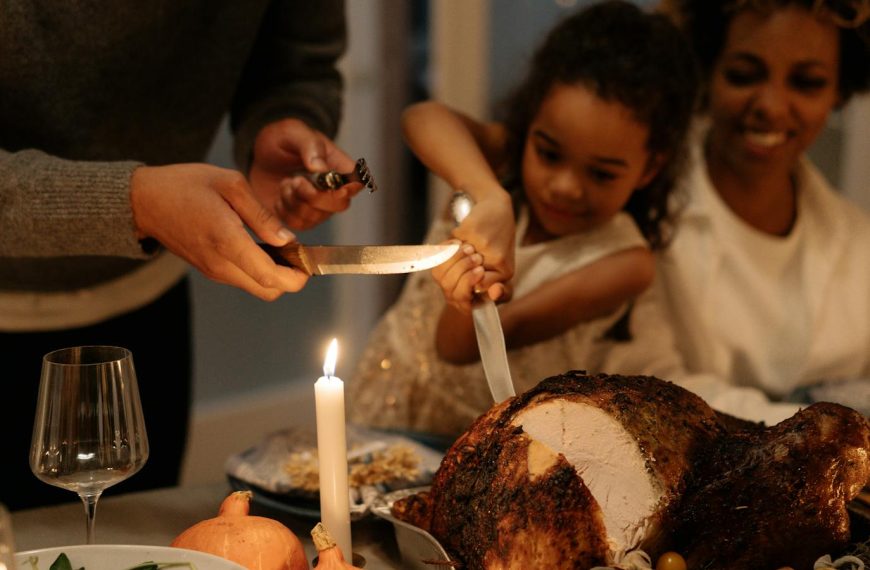 Family gathering around a beautifully roasted turkey for a Thanksgiving dinner celebration.