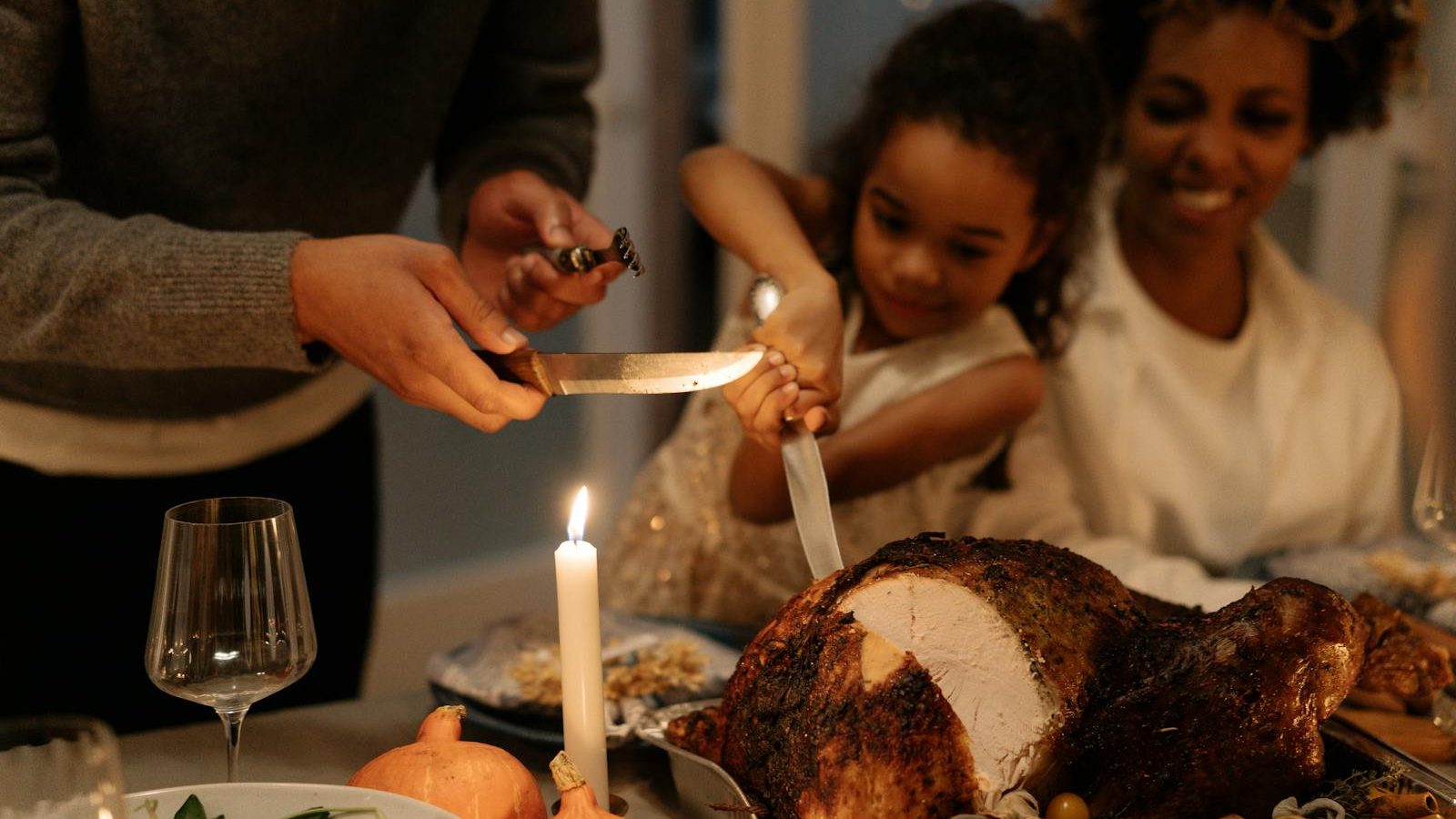 Family gathering around a beautifully roasted turkey for a Thanksgiving dinner celebration.