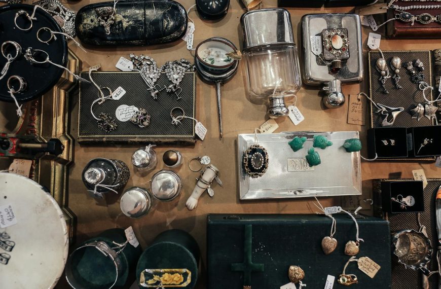 Aerial view of a vintage jewelry and antiques market display with various items for sale.