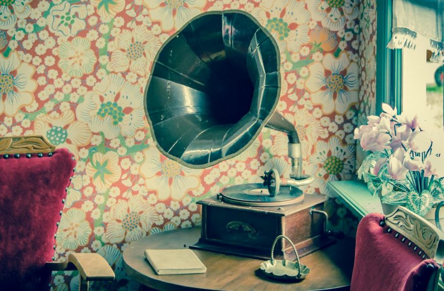 Retro gramophone in a room with floral wallpaper and vintage decor.