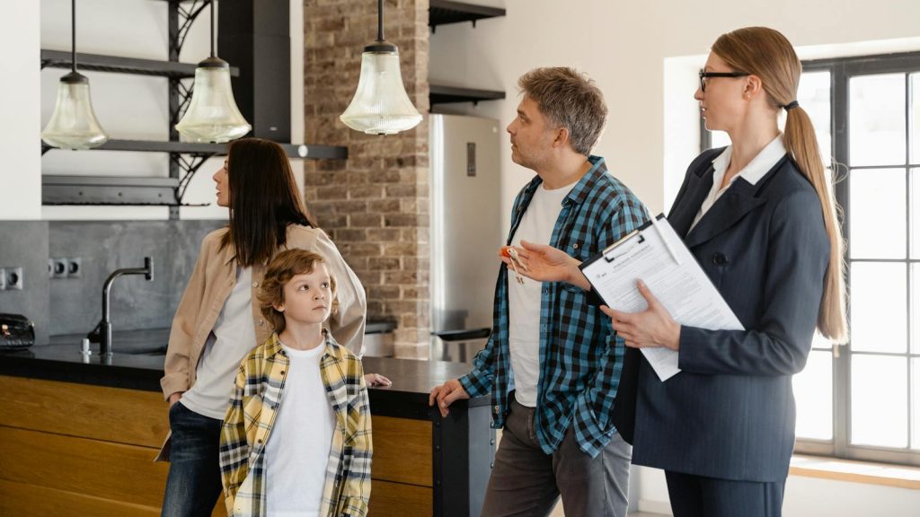 A family converses with a real estate agent about a modern home interior.