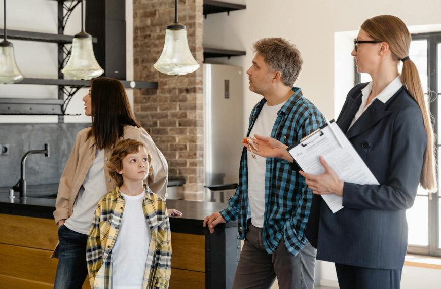 A family converses with a real estate agent about a modern home interior.