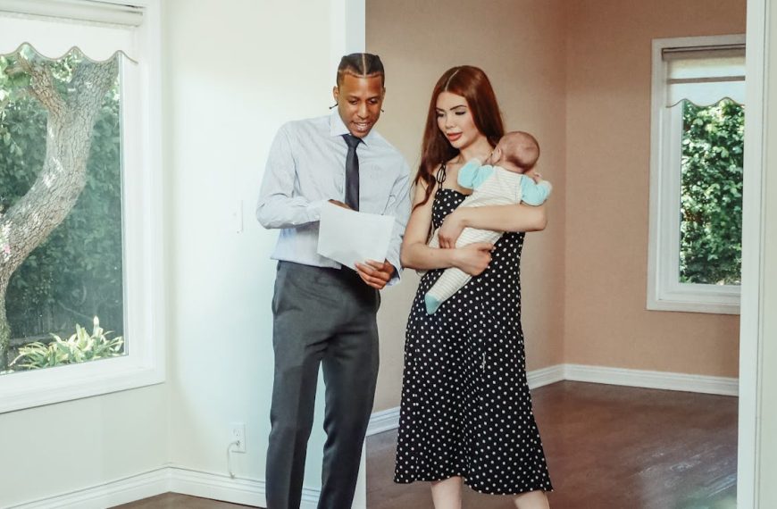 A family explores their potential new home with a realtor during a house tour.