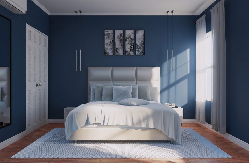 a bedroom with blue walls and a white bed