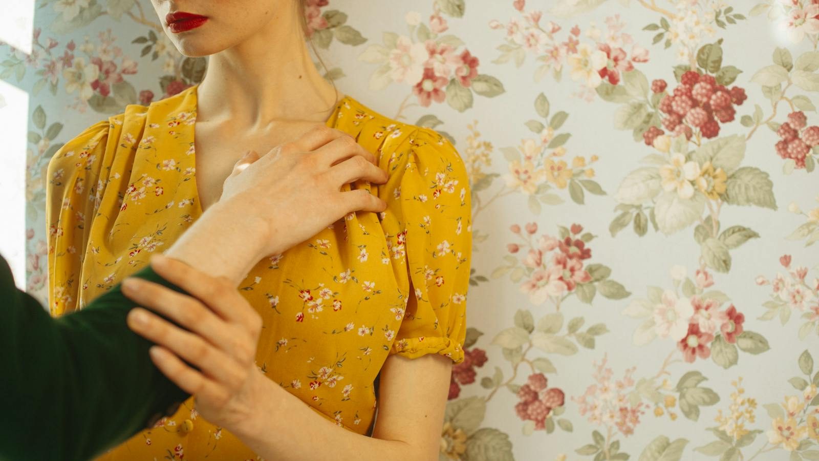 Close-up portrait of a woman in a yellow floral dress with an expressive pose.