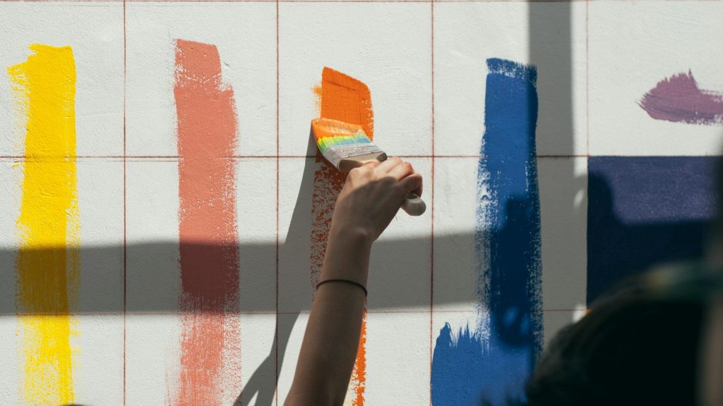 person painting wall