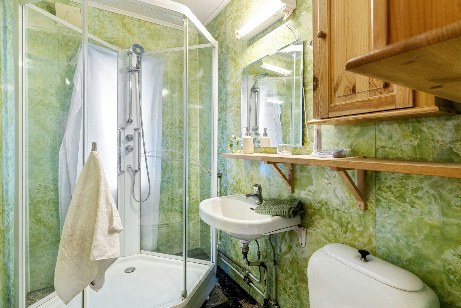 A bathroom with a sink, toilet, and shower